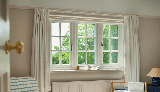 white upvc sculptured sash windows with cream curtains