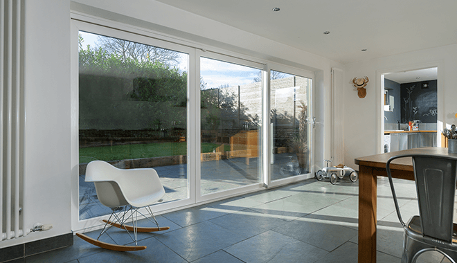 White uPVC sliding doors leading to a bright garden